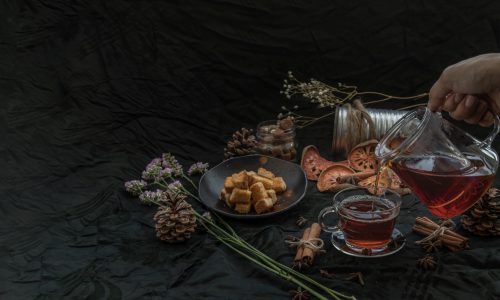 Bael Fruit Tea Is Poured From A Kettle Into Glass Cup With Bark